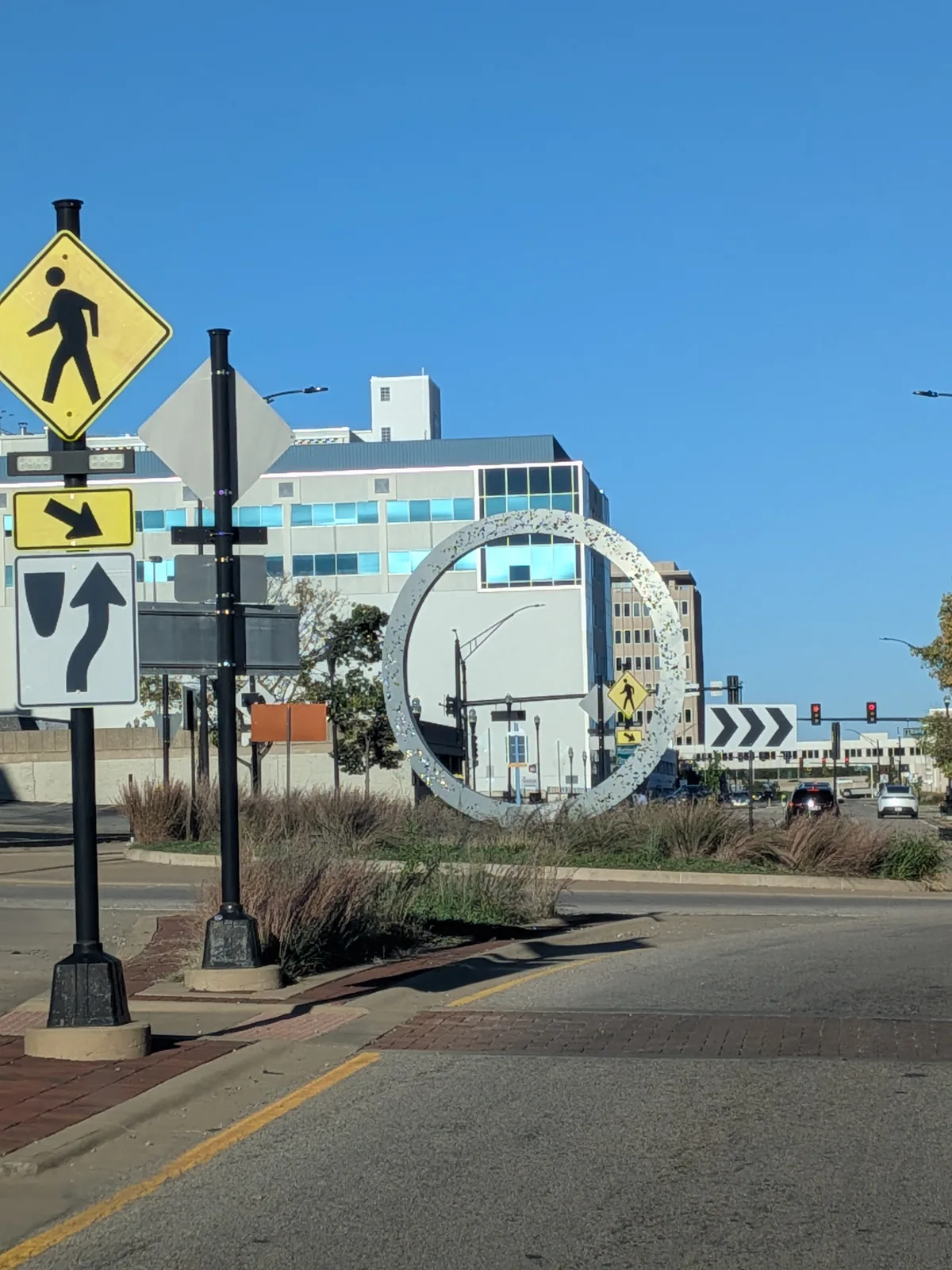 A large sparkling ring sculpture in a downtown Peoria median