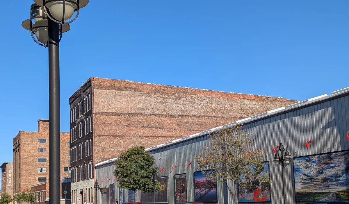 Old brick warehouses in the Warehouse District beside an outdoor art wall